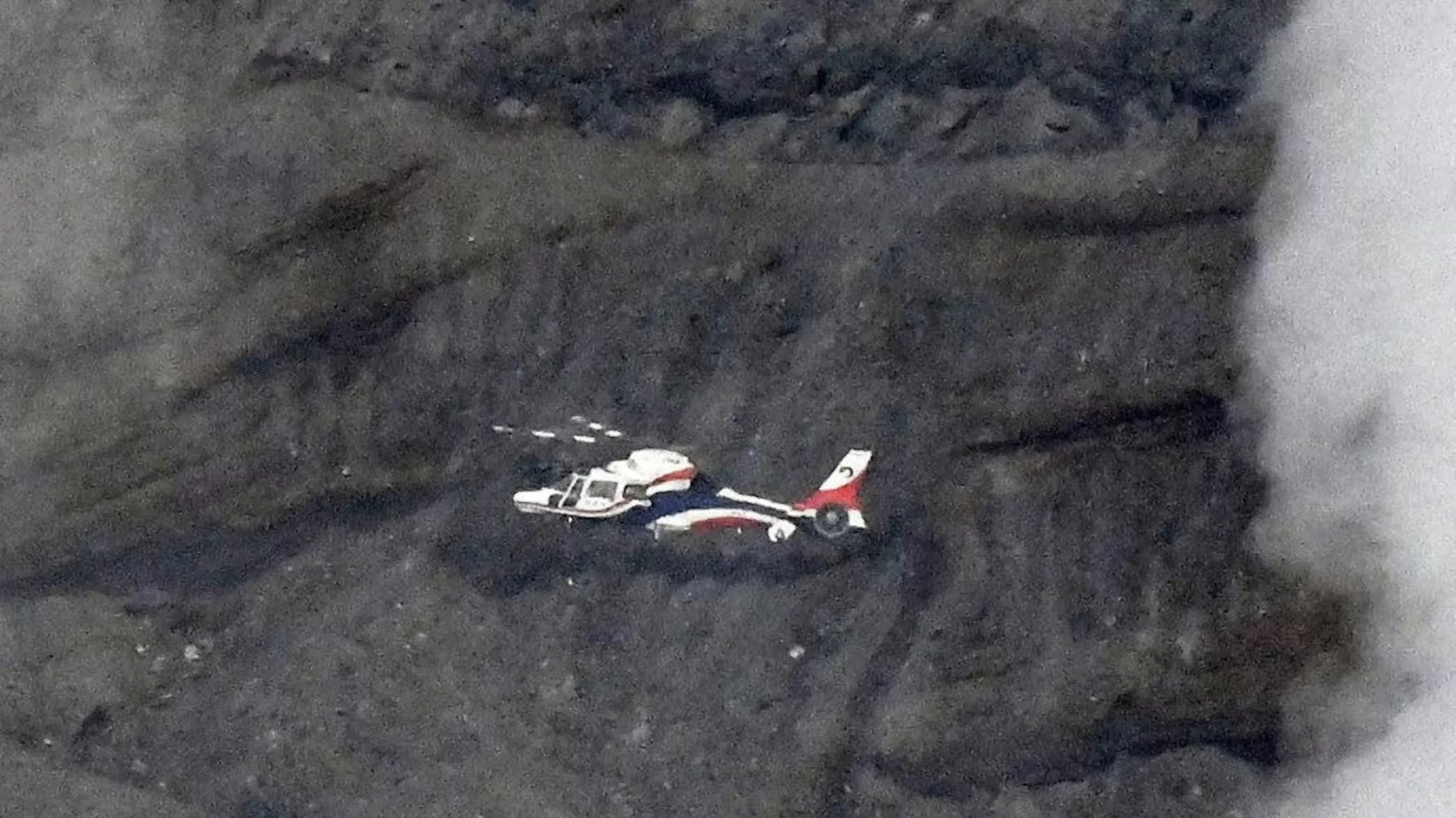 Rescuers spot wreckage possibly from a helicopter that went missing near a volcano in Japan